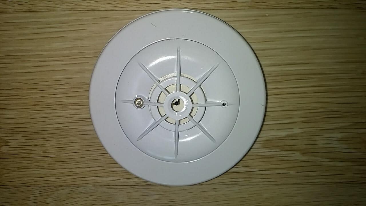 White Smoke Detector On Wooden Background | Home Security System Gadgets